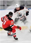  ?? AP PHOTO ?? SNOW PROBLEM: New Jersey’s Kyle Palmieri and Edmonton’s Ryan Strome vie for the puck during yesterday’s game between the teams in Gothenburg, Sweden.