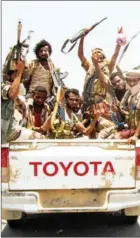  ?? SALEH AL-OBEIDI/AFP ?? Yemeni fighters loyal to the Saudi-backed Yemeni president pose for a picture in the back of a Toyota pickup truck, raising their machine guns on April 15, on the road leading to Khaled Ibn Al-Walid base, near the government-held Red Sea port town of...