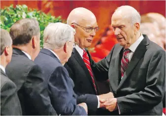  ?? THE ASSOCIATED PRESS ?? Russell M. Nelson, right, greets members of the Quorum of the Twelve Apostles at a Mormon conference in Salt Lake City last September.