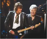  ?? Associated Press photo ?? Jon Bon Jovi, right, watches Richie Sambora play guitar during the Rock and Roll Hall of Fame Induction ceremony, Saturday, in Cleveland.