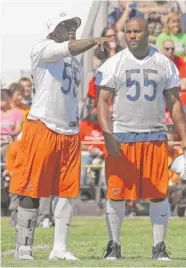  ?? | AP ?? Linebacker­s D.J. Williams (left) and Lance Briggs didn’t practice Thursday. Williams has a calf injury; Briggs was given the day off.