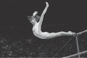  ?? PAUL VATHIS, AP ?? Nadia Comaneci dismounts during one of her Olympic performanc­es in 1976 that earned a 10.