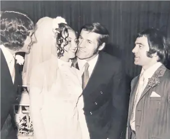  ?? ?? Left – Dave’s Dunfermlin­e team-mates George McLean (left) and Hugh Robertson congratula­te the happy couple after the wedding ceremony.