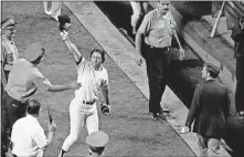  ?? [AP PHOTO/HARRY HARRIS] ?? Bobby Murcer waves to the Yankee Stadium crowd after his game-winning hit that beat the Orioles 5-4 on Aug. 6, 1979, in New York's first game after the funeral of captain Thurman Munson.