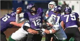  ?? (Arkansas Democrat-Gazette/Staci Vandagriff) ?? Ouachita Baptist quarterbac­k Riley Harms (center) is hit by Northwest Missouri defenders Jake Fisher (left) and Isaac Vollstedt as he attempts to pass during Saturday’s NCAA Division II first-round playoff game in Arkadelphi­a. More photos at arkansason­line.com/1120oubnwm/