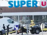  ?? RAYMOND ROIG/AFP/GETTY IMAGES ?? Police remove a van from the Super U supermarke­t in Trebes, France, on Friday after a hostage-taking there.