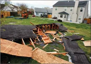  ?? The Associated Press ?? TORNADO DAMAGE: A roof blew over Virginia Beach’s Rock Creek neighborho­od and landed in the backyard of a home on Saturday in Virginia Beach, Va. Authoritie­s say dozens of homes were damaged and a church in Chesapeake nearly destroyed.