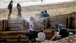  ??  ?? Thrill of the grill... millions of visitors love a barbecue on the beach at Brighton but council chiefs say they raise CO2 levels