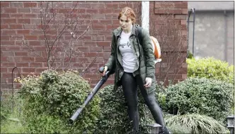  ??  ?? Country singer Caylee Hammack uses a leaf blower to clear a sidewalk as she does landscapin­g work in Mt. Juliet, Tenn.