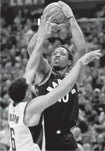  ?? NATHAN DENETTE, THE CANADIAN PRESS ?? Raptors guard DeMar DeRozan shoots over Pacers guard Cory Joseph during first-half action in Toronto on Friday night.