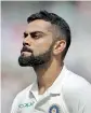  ?? - AFP ?? India's Virat Kohli walks back to the pavilion after losing his wicket for 51