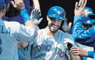  ?? DUANE BURLESON THE ASSOCIATED PRESS ?? Toronto Blue Jays’ Randal Grichuk celebrates with teammates after hitting a two-run home run against the Tigers Sunday afternoon in Detroit. The Blue Jays won, 8-4, snapping a five-game losing streak.