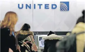  ?? [AP FILE PHOTO] ?? People stand in line at a United Airlines counter at LaGuardia Airport in New York. A dog died on a United Airlines plane after a flight attendant ordered its owner to put the animal in the plane’s overhead bin. United said Tuesday that it took full...