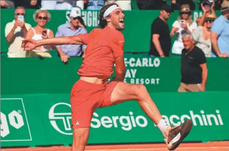  ?? AFP ?? Greece's Stefanos Tsitsipas celebrates after beating Norway's Casper Ruud to win the Monte Carlo Masters title on Sunday. The Greek won 6-1, 6-4 in a display of “ruthless” tennis for his third crown in the Principali­ty of Monaco.