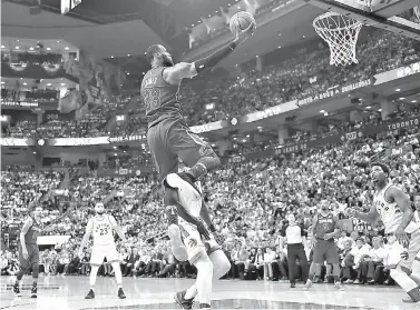  ?? Frank Gunn/The Canadian Press via AP ?? ■ Cleveland Cavaliers forward LeBron James (23) shoots against the Toronto Raptors during the second half of Game 2 of an NBA basketball playoffs second-round series Thursday in Toronto.