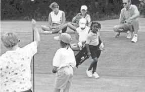  ?? STACKHOUSE FAMILY PHOTO ?? A young Mariah Stackhouse, center, carries her clubs on the course.