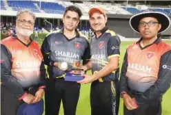  ??  ?? ↑ DHL’S Sagheer Afridi and Asif Shadab pose with the officials after sharing the man of the match award.