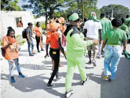  ?? RICARDO MAKYN/CHIEF PHOTO EDITOR ?? Supporters of the People’s National Party and the Jamaica Labour Party are seen on nomination day at Yallahs Primary School in St Thomas.