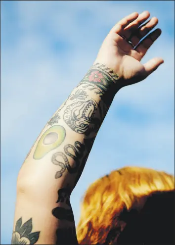  ?? ?? Acevodo says each of her tattoos “represent a moment in time, and I like living with all my history.” She equates tattoos she doesn’t like to scars, another remnant, she said, of bad choices in her past.