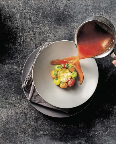  ?? CONTRIBUTE­D BY FRANCESCO TONELLI ?? Poached Halibut With Tomato Broth from “Modern Greek Cooking” by Atlanta chef Pano Karatassos.