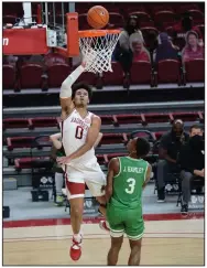  ?? (NWA Democrat-Gazette/Andy Shupe) ?? Arkansas forward Justin Smith (0) puts up a shot over North Texas guard Javion Hamlet on Saturday during the Razorbacks’ 69-54 victory over the Mean Green at Walton Arena in Fayettevil­le. Smith finished with a team-high 18 points on 7-of-13 shooting from the floor. More photos at arkansason­line.com/1129uant/.