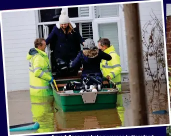  ??  ?? Saved: Rescuers help a woman in Hereford