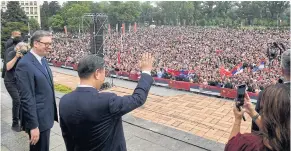  ?? AFP ?? Chinese President Xi Jinping, accompanie­d by Serbian President Aleksandar Vucic, greets people outside the Palace of Serbia in Belgrade on May 8.