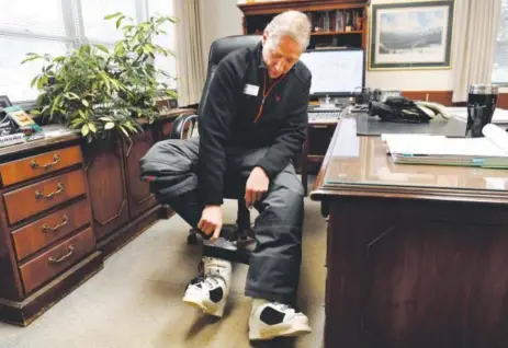  ??  ?? Winter Park president and CEO Gary DeFrange puts on ski boots in his office before hitting the slopes at the Denver-owned ski area. DeFrange, 69, will be retiring at the end of March after two decades running the ski area. Photos by Andy Cross, The...
