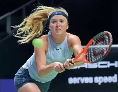  ?? AFP ?? Elina Svitolina of Ukraine hits a return against Simona Halep of Romania during the WTA Finals tournament in Singapore. —