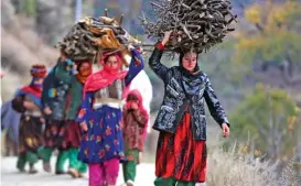  ?? (AFP) ?? Afghan women are seen carrying firewood in Dara-i Noor district of Nangarhar province on Sunday