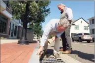  ?? Christian Abraham / Hearst Connecticu­t Media ?? Al Tibbetts and David Genovese look at storm drains after a storm.