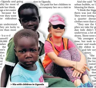  ??  ?? > Nia with children in Uganda