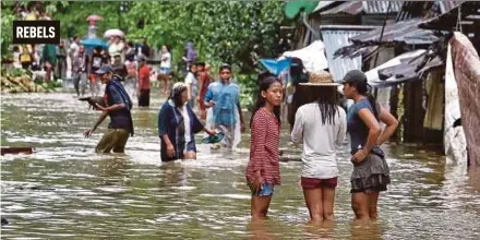  ?? AFP PIC ?? Villagers wading through a flooded street in Brgy Calingatan, Borongan, Samar island, the Philippine­s, on Saturday.