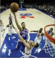  ?? MATT SLOCUM - AP ?? The Philadelph­ia 76ers’ Ben Simmons (25) goes up for a shot against the Cavaliers’ Kevin Love during the first half of an NBA game, Monday, in Philadelph­ia.