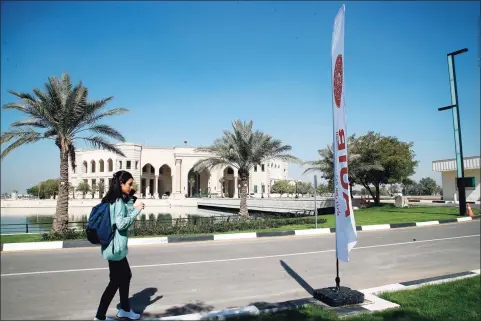  ?? Hadi Mizban / Associated Press ?? A student walks outside the newly inaugurate­d American University in Baghdad, Iraq, on Monday. Encircled by the blue waters of a man-made lake are palaces turned to faculties promising an “American” schooling to meet the needs of Iraq’s growing youth, in a city where education has lagged since the 2003 U.S.-led invasion that toppled Saddam Hussein and unemployme­nt has since soared.