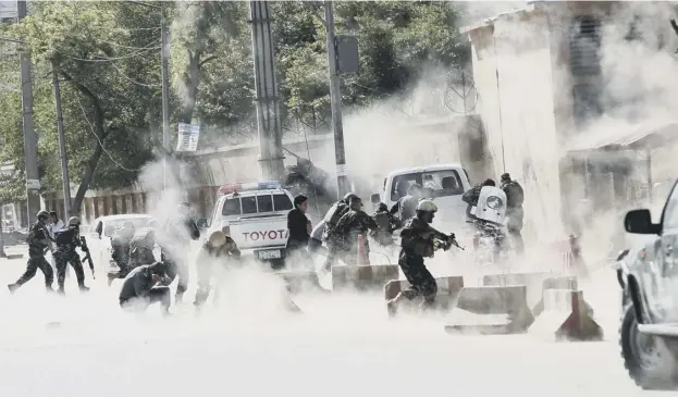  ?? PICTURE: MASSOUD HOSSAINI/AP ?? 0 Security forces run from the site of a second suicide attack in Kabul yesterday in which at least 25 people, including journalist­s, died