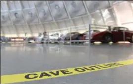  ??  ?? Tape on the floor marks the location of the cave under the Skydome building of the National Corvette Museum in Bowling Green, Ky. The car-swallowing sinkhole has been fixed but not forgotten at the museum. Yellow tape now marks the boundaries of the...