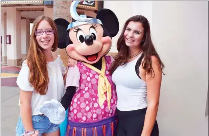  ?? STEVE MacNAULL/The Okanagan Weekend ?? Spanish exchange student Patri Gil Diez, left, Minnie Mouse, dressed as a 1920s flapper for Halloween, and Grace MacNaull serendipit­ously met on Buena Vista Street in Disneyland’s California Adventure theme park.