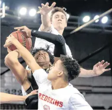  ?? [PHOTO BY CHRIS LANDSBERGE­R, THE OKLAHOMAN] ?? Kingston’s Jacob Whipkey and Stoney Lowe defend on Hugo’s Houston Greggs during Friday’s Class 3A boys state semifinals basketball game at the State Fair Arena in Oklahoma City.