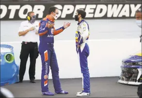  ?? Mark Humphrey / Associated Press ?? Drivers Joey Logano, left, and Chase Elliott talk following Sunday’s race at Bristol Motor Speedway in Bristol, Tenn.