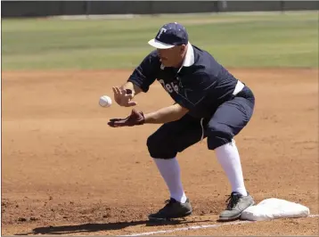  ?? PHOTO BY ANDREW FOULK ?? Chris Adams of the Temecula Dear Bros makes a play in a Southern California Vintage Base Ball League game at Citrus Hill High School in Perris on May 14. The players use equipment similar to what was common in 1886 — note the barelyther­e fielder’s glove.