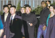  ?? Yong Teck Lim / Associated Press ?? North Korea leader Kim Jong Un, center, is escorted by his security delegation as he visits Marina Bay in Singapore on Monday.