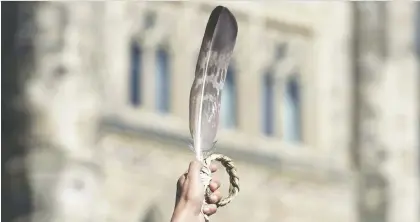  ?? ADRIAN WYLD/THE CANADIAN PRESS FILES ?? An eagle feather is held up during a rally for Missing and Murdered Indigenous Women and Girls in Ottawa in 2016. Canada is failing to promote “equal justice under law” when it comes to First Nations governance, says Diane Francis.