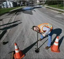  ?? JIM NOELKER / STAFF ?? County water supply supervisor Keith Baker listens for water running through a valve on South Boulevard in Kettering in April. A rate increase will help cover maintenanc­e costs.