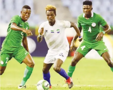  ??  ?? Nathaniel Tongo Vula (C) of Sierra Leone is challneged by CHAN Eagles' Okoro Osadebamwe­n (L) and Aremu Afeez (R) during the 2017 WAFU Cup match at the Cape Coast Stadium in Ghana