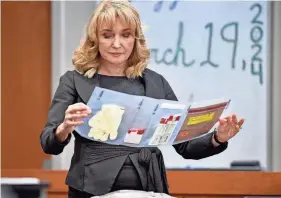  ?? MIKE LANG/HERALD-TRIBUNE ?? Assistant State Attorney Karen Fraivillig looks at evidence collected from the vehicle of Tyren Kinard. Juan Salazar-Diaz was found guilty in the September 2018 murder of Kinard in North Port.