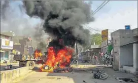  ?? PTI ?? Smoke billows from vehicles during Bharat Bandh called by Dalit organisati­ons against the alleged dilution of Scheduled Castes/Scheduled Tribes Act, in Alwar on Monday.