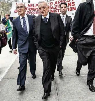  ?? Vanessa Carvalho/Brazil Photo Press/Folhapress ?? PONTAPÉ INICIAL O ex-presidente da CBF José Maria Marin, acusado no escândalo da Fifa, deixa corte em Nova York; houve protesto no primeiro dia de julgamento