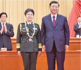  ??  ?? Chinese President Xi Jinping (right), presents a medal to Chen Wei, recipient of the national honorary title, “the People’s Hero,” in Beijing, China on September 8, 2020.