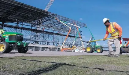  ?? JOE CAVARETTA/SOUTH FLORIDA SUN SENTINEL ?? Turf is installed during a behind-the-scenes look at ongoing constructi­on of the Inter Miami stadium in Fort Lauderdale on Wednesday.